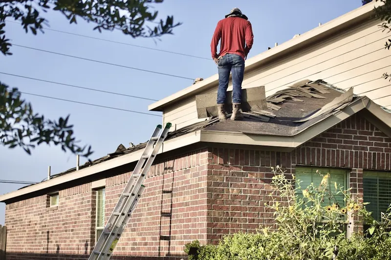 Professional roofer working on a residential roof in Lubbock